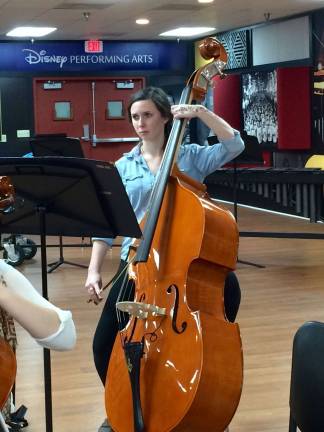 VTHS orchestra, choir performs in Disney World Hannah Lowry is shown on string bass.