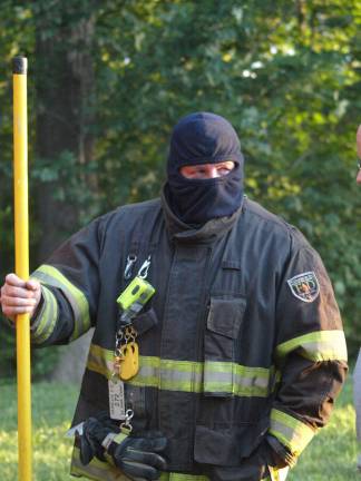 Franklin Fire Department Assistant Chief Troy Kays takes a break from the heat.