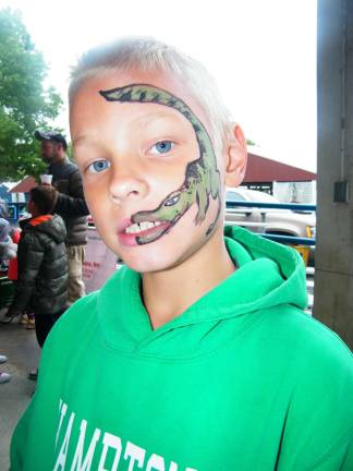 Rain doesn't affect fall festival Sussex Christian School third-grader Caleb Kuperus, 8, of Fredon shows his alligator teeth.