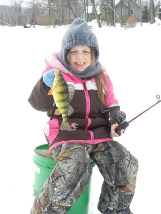 This photo provided by Albert Panicci shows his daughter, Kaitlyn, 5, ice fishing on Highland Lakes. She caught a 24-inch pickerel and a 12-inch yellow perch.