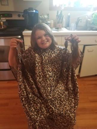 Sisters donate hair to Wigs for Kids Gabryella Abbot shows off the hair she is donating.