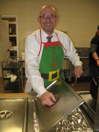 Seniors rock the center for Christmas Vernon Mayor Harry Shortway gets ready to serve up the holiday luncheon.