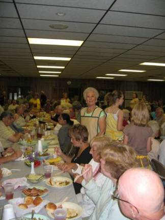 Loretta Dunn helps serve a full firehouse of diners at the Harvest Home Dinner to benefit the Beemerville Church.