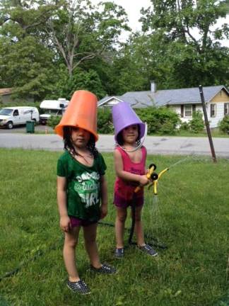 My summer Leprechaun's. The twins pretending they were leprechauns. The pails were their hat. The sprinkler was their rainbow. Photo courtesy of Cindy.