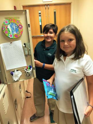 Fifth graders Antonio Puopolo of Montague, left, and Robin Guarda of Lake Hopatcong stop at their lockers to switch books on the first day of school at Hilltop on Sept. 7