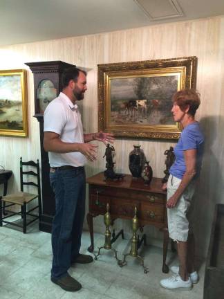 Sussex County icon's collection up for auction this weekend PHOTOS BY LAURIE GORDON Auctioneer Ray Hartzel's son, John Hartzel, prepares for the weekend's auction with Peg Ewing, the late Richard Roy's sister.