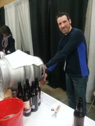 Jason Wills of Deville, volunteers at the festival to pour local brews such as Clown Shoes.