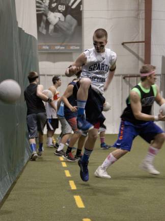 Locals battle it out in dodgeball compeitition for charity A member of the Finger Licking Goods jumps to avoid being hit with a dodgeball.