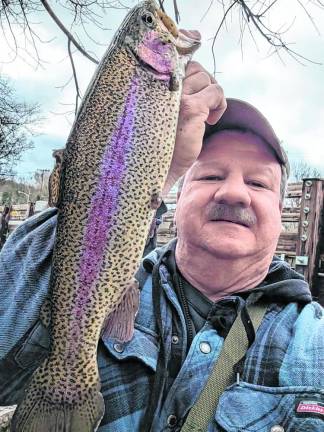 Sussex County History Today: ‘Fishin’ Blues’ FI1 Earl Hornyak holds a trout that he caught on opening day, Saturday, April 5. He and his friend Bill Repasy took a difficult path through dense shrubbery to get to an exceptional location with huge trout. (Photo by Bill Truran)