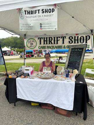 Julie Gay of Lift My Mood Thrift Shop mans a table at the street fair.