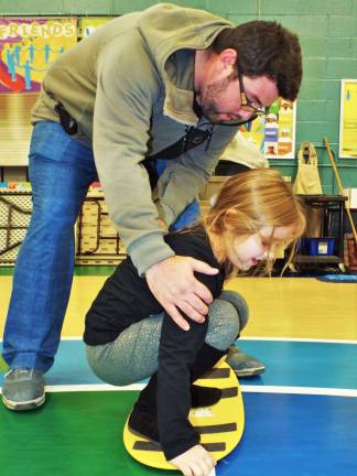 Three-year Mountain Creek snowboard trainer Matthew McGarry teaches a Walnut Ridge Primary School student how to spin on a snowboard all by herself!