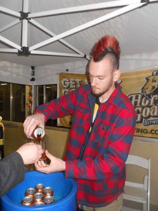 Photos by Alexis Tarrazi Connor Hopkins of Flanders pours beer for Horny Goat Brewing Company during the Brew Fest in Augusta in 2014.