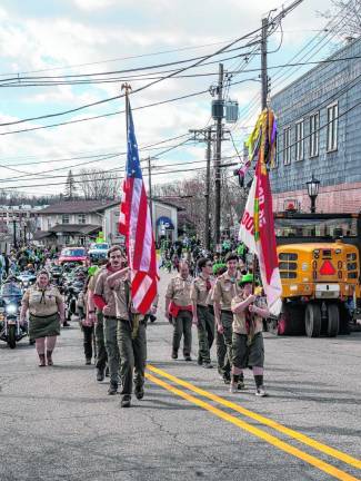 The Boy Scouts Troop 85 Color Guard marches in the parade.