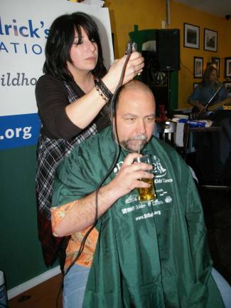 Dale Meyer of Vernon gets a trim by haircutter Stacy Dolan of Franklin&#xfe;&#xc4;&#xf4;s Rumours II. Meyer raised nearly $500 to aid the fight against children&#xfe;&#xc4;&#xf4;s cancer.