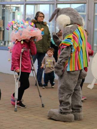 PHOTOS BY MARK LICHTENWALNER The Easter Bunny greets a participant in the Easter bonnet contest at Heaven Hill Farm.
