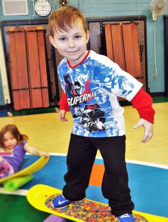 Walnut Ridge Primary School student Ayden Maxwell balances on his 'snowboard' Nov. 14th with Riglet instructors from Mountain Creek leading the way!