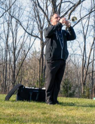 Rick Roberts plays taps during the ceremony.