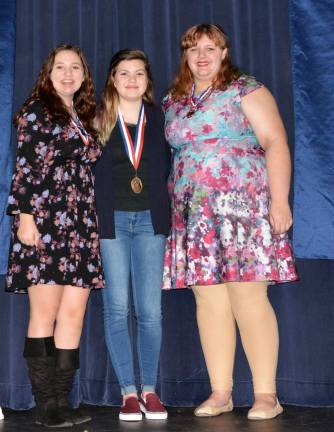 Freshman Reyna Whitty (center), who recited The Layers by Stanley Kunitz. Sidney Sparta, a sophomore (left) and Zoe Heath, a senior (right), earned second and third place respectively.
