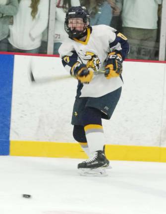 The puck slides across the ice after being struck by Vernon's Cole Brennan.