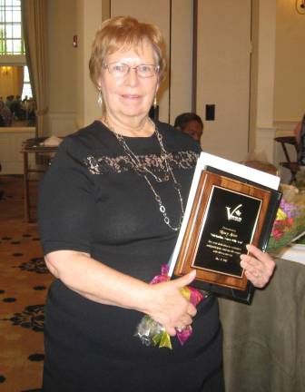 Nancy Adam proudly displays her newly won award.