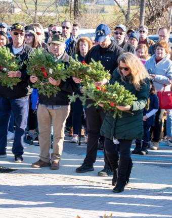Lois Johann prepares to place a wreath in honor of the U.S. Space Force during a Wreaths Across America ceremony. Her son is in training for the Space Force.