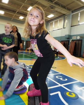 Arabella Rivera tries out her snowboarding moves, guided by Mountain Creek Riglet program instructors at Walnut Ridge School Monday, Nov. 14.