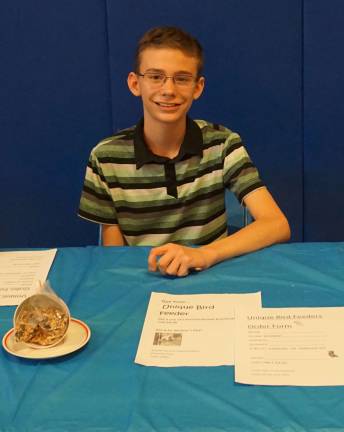 Sussex MS students sell their own products at market Joe Cimaglia of teacup Bird Feeders takes orders because he is sold out.