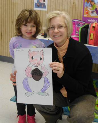Jenise Sileo is shown with Hannah Truesdell 3L displaying her art work.