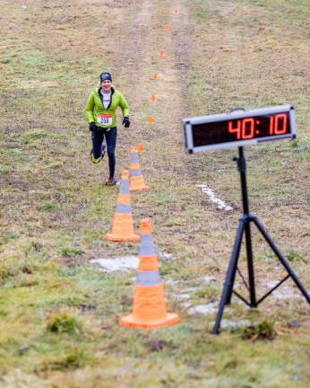 Elizabeth O’Connor, 58, of Bloomingdale crosses the finish line. She was the first female to finish the race and the third overall. Her time was 40:12.5.