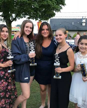 From left, Nina Strowe, Izabella Nowicki, Samantha Perez, and Natalie Torres pictured with their music instructor Elisa Girlando (middle) of Elisa Girlando Studios of Sparta after winning first place at Talent Day.