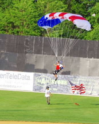 Sporting patriotic colors a skydiver from the Skydive Sussex skydive center makes a smooth landing on the field during pre-game festivities.