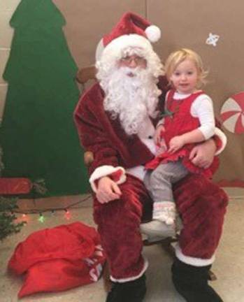 Santa visits Lil KEEPers Caroline is happy to talk to Santa.