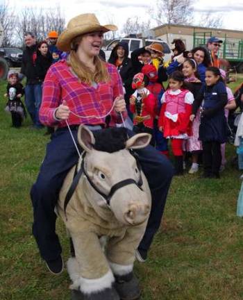 Dressed as a cowgirl with her faithful horse Maximus, Heaven Hill Farm employee Lisa Albertini, 21, of Vernon helped corral the contestants for the judges to evaluate.