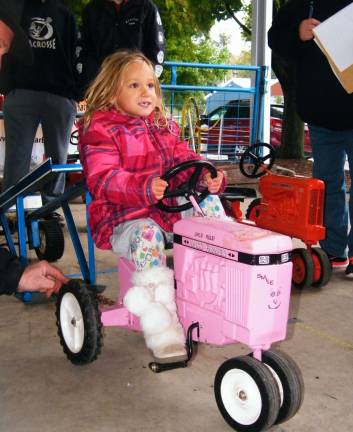 Rain doesn't affect fall festival Chloe Esposito, 4, of Wantage holds her head high, putting the pedal to the metal, and won first place in her division.