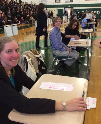 From left, Rose Wolthoff and Matt Maass wait for their scores to be tallied in the Super Quiz portion of the Academic Decathlon.