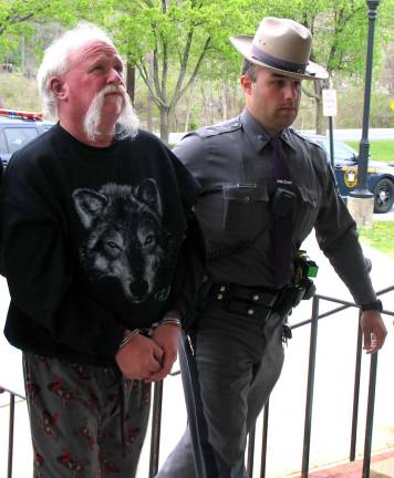 A New York State tropper escorts Charles M. Sawtelle, 53, of Westbookville, into Warwick Town Court, where he was arraigned on charges of second-degree conspiracy and fifth-degree criminal possession of a controlled substance.