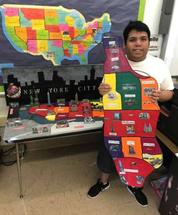 Michael Miranda displays the board of Manhattan he made in preparation for a field trip to famous landmarks.