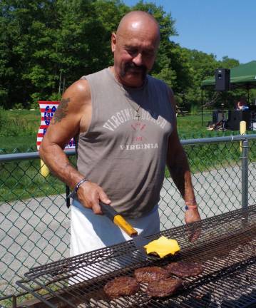 With his recurring role as master of the grill, George Tadiello kept the folks happy during the Barry Lakes Annual Community Picnic.