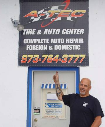 Joe Lisa, owner of the A-Tec Tire &amp; Auto Center says &#x201c;Look for this sign&#x201d;.