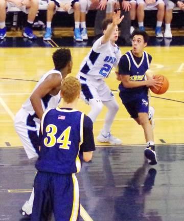 Vernon's Jacob Rodriguez makes a move towards the basket with the ball while covered by Sparta's Jack Simon.