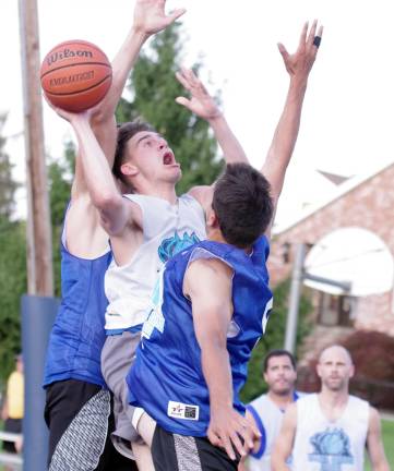 Team Smalley's Nick Lucas handles the ball while covered by two Team Tobin defenders.