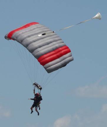 Tandem skydivers are shown descending above Sussex Airport during the third annual &#xfe;&#xc4;&#xfa;That's How We Roll Boogie&#xfe;&#xc4;&#xf9; skydiving event.