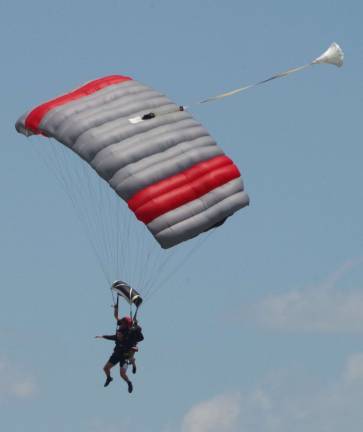 Perfect weather for skydiving ‘Boogie’ Tandem skydivers are shown descending above Sussex Airport during the third annual þÄúThat's How We Roll BoogieþÄù skydiving event.