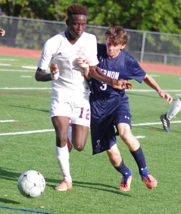Vernon's Omar Ba and Vernon's Nick Lavorini bang into each other while in pursuit of the ball.