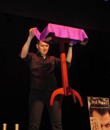 Joel Meyer performs at SCCC Magician Joel Meyers makes a table levitate.
