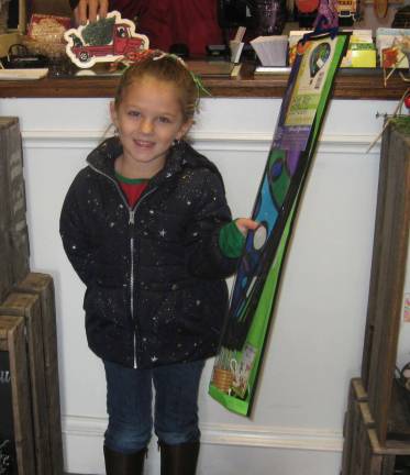 Local businesses celebrated on Saturday Mackenzie Speid gets in the spirit by getting a gift for her aunt.