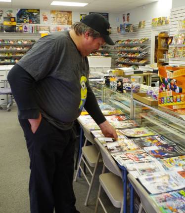 Vernon firefighter Guy Kovalcik looks through the free comics at Bob's Collectables. He also made some purchases during his visit.