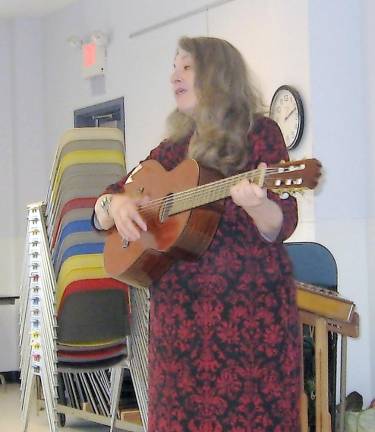 Songstress Linda Russell strums and sings songs of America’s past.