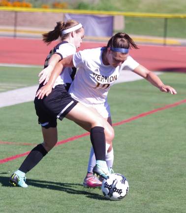 West Milford's Riley McGill challenges Vernon's Kathleen Smaldone for control of the ball.