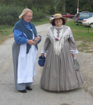 Denise Delimon (left) and Diane Cece stroll the encampment as a camp nurse and Pinkerton detective&#x2019;s wife.